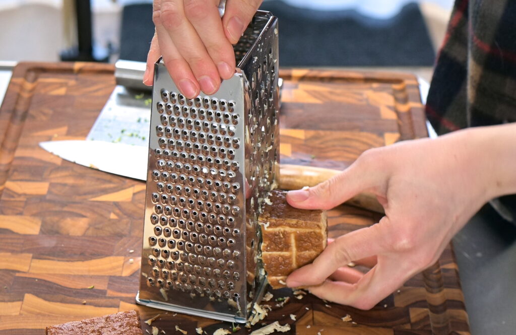Grate firm tofu using a grater
