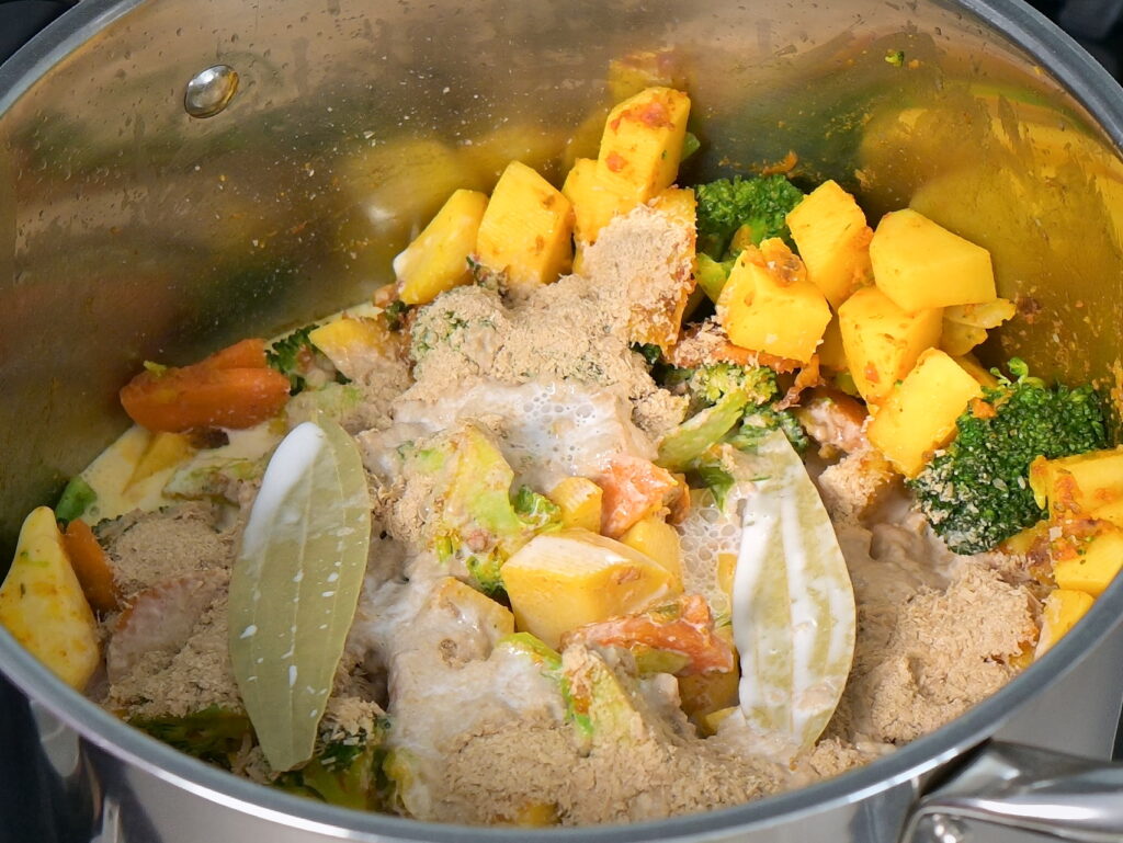 Add bay leaves and coconut milk