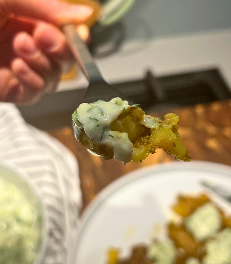 smashed potato with tzatziki bite on a fork