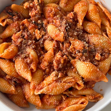 Quick Tofu and Lentils Bolognese bowl with shell pasta close up