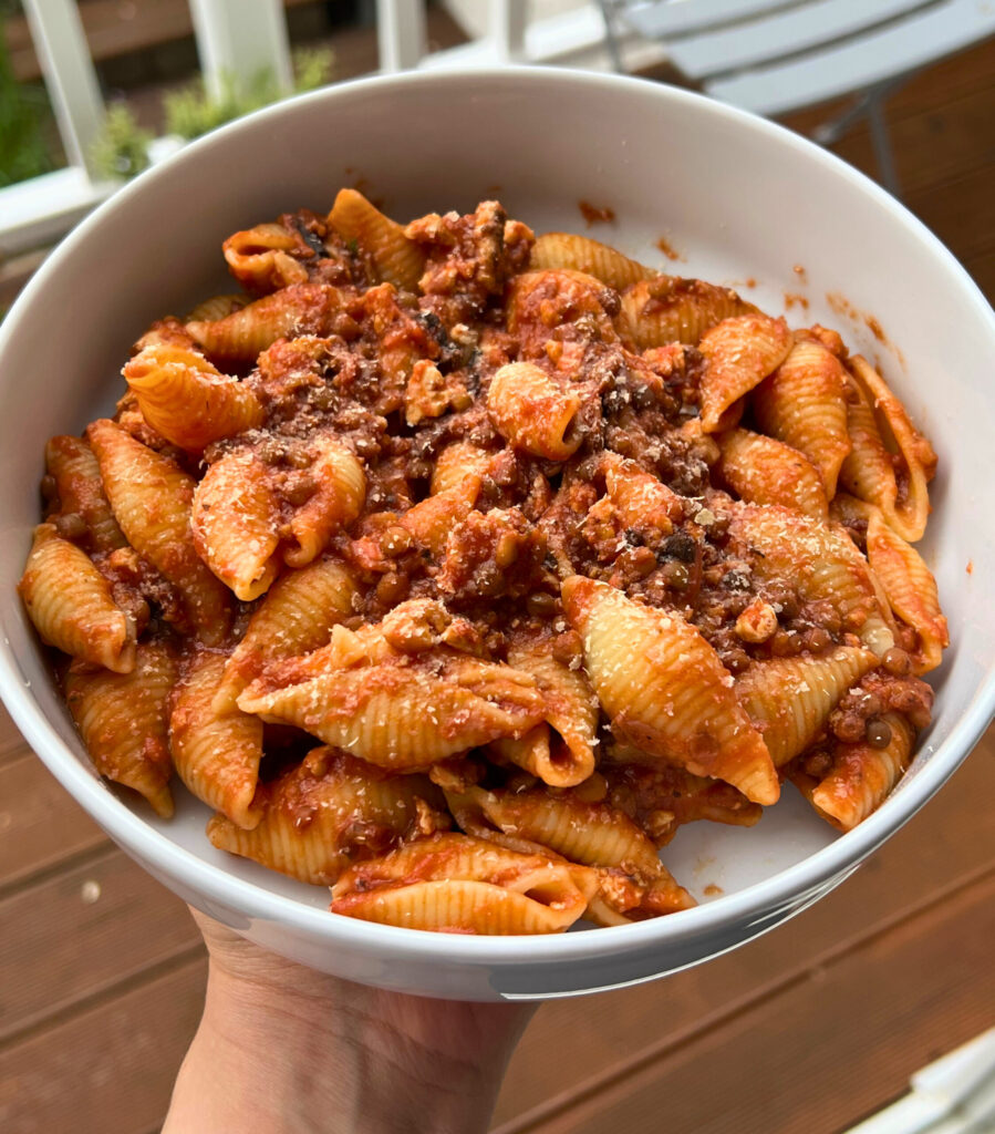 Quick Tofu and Lentils Bolognese bowl with shell pasta close up