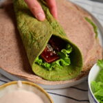 quinoa and red lentils green wraps on a towel