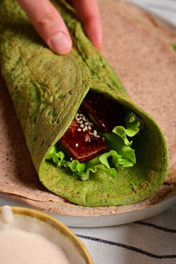 quinoa and red lentils green wraps on a towel