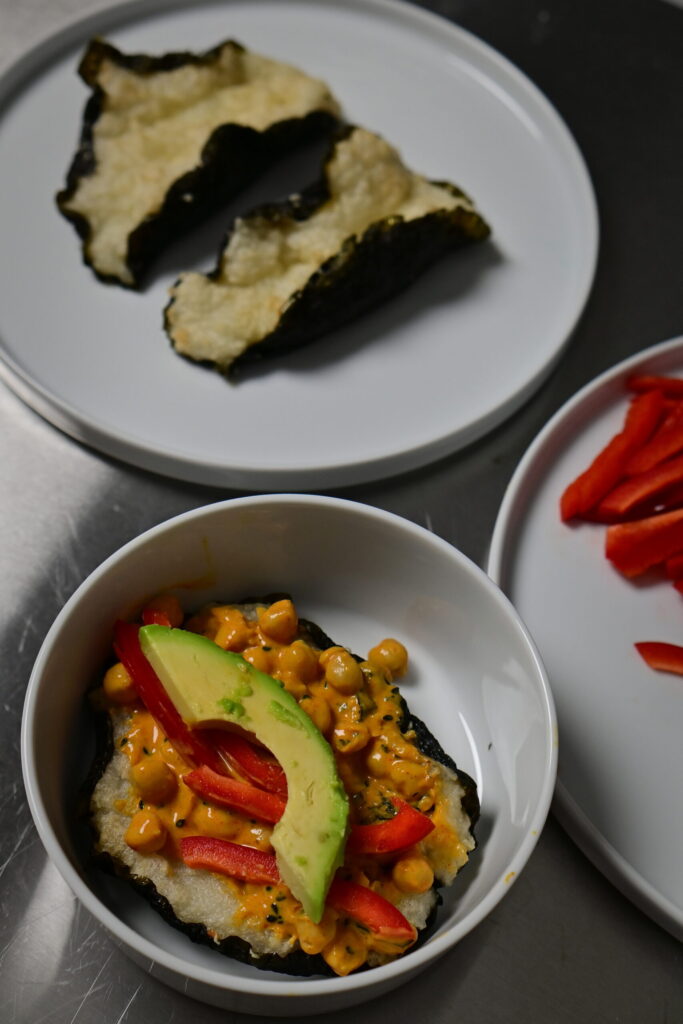 yoghurt Curry Chickpeas in sushi taco with avocado and peppers in a bowl. empty sushi tacos
