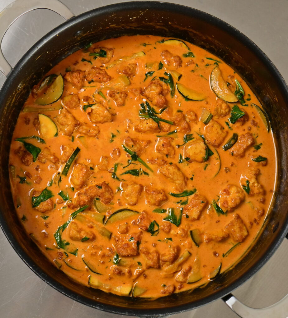 a pot with coconut lime tofu with herbs