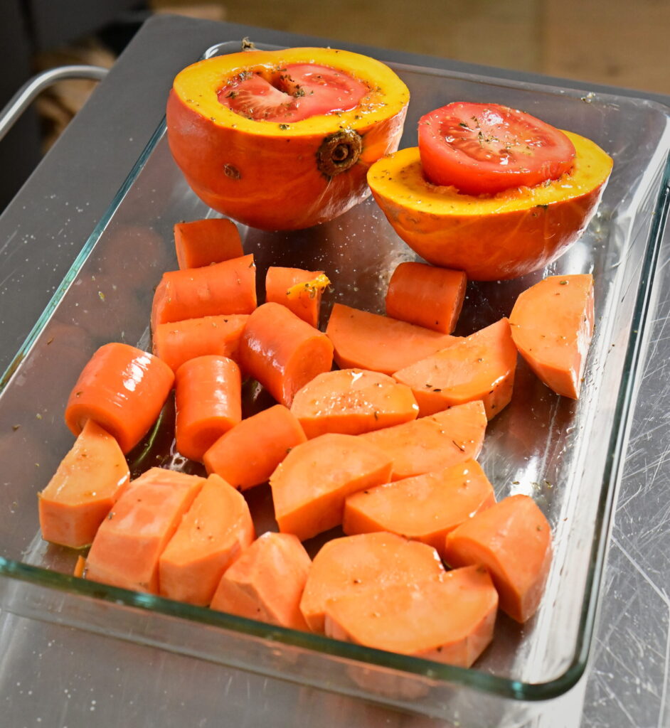 orange veggies prior roasting in a glass dish