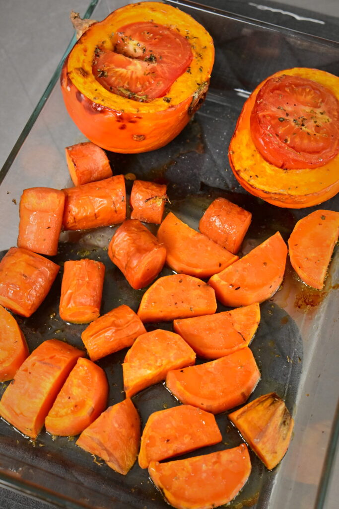 orange veggies after roasting in a glass dish