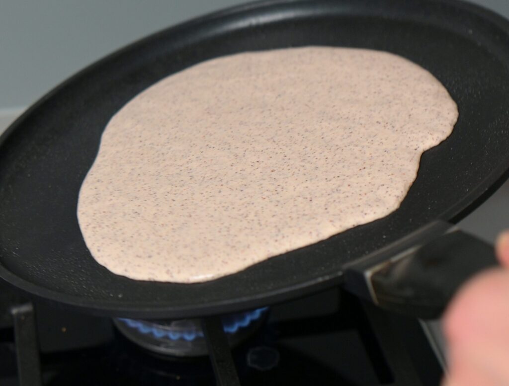 Tilt the pan to spread evenly