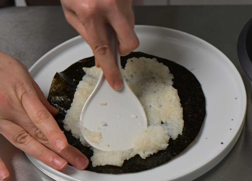 Spread a thin layer of the cooked rice