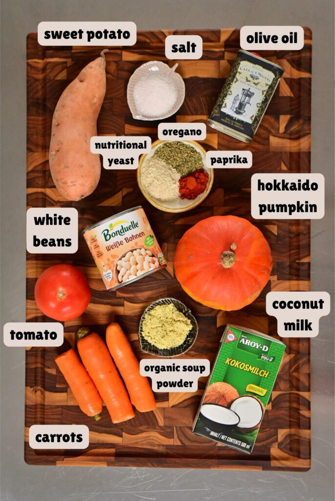 silky bright orange vegetables soup ingredients placed on a wooden board