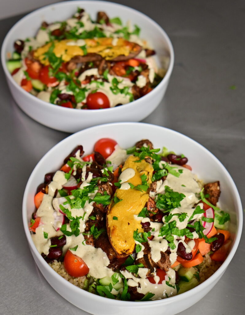 meal prep budha bowl with tahini dressing, sweet potato, veggies