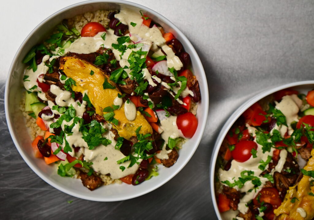 meal prep budha bowl with tahini dressing, sweet potato, veggies