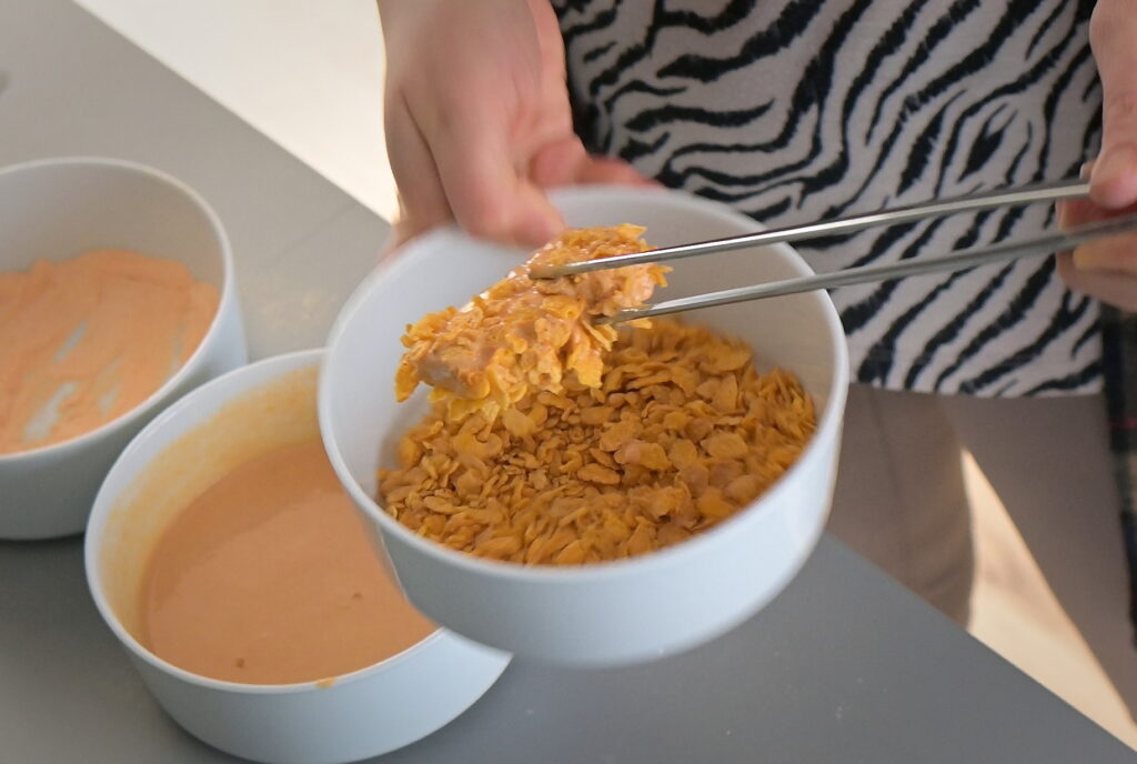 Dip tofu into cornflakes